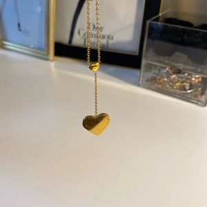 Gold pleated heart shaped necklace